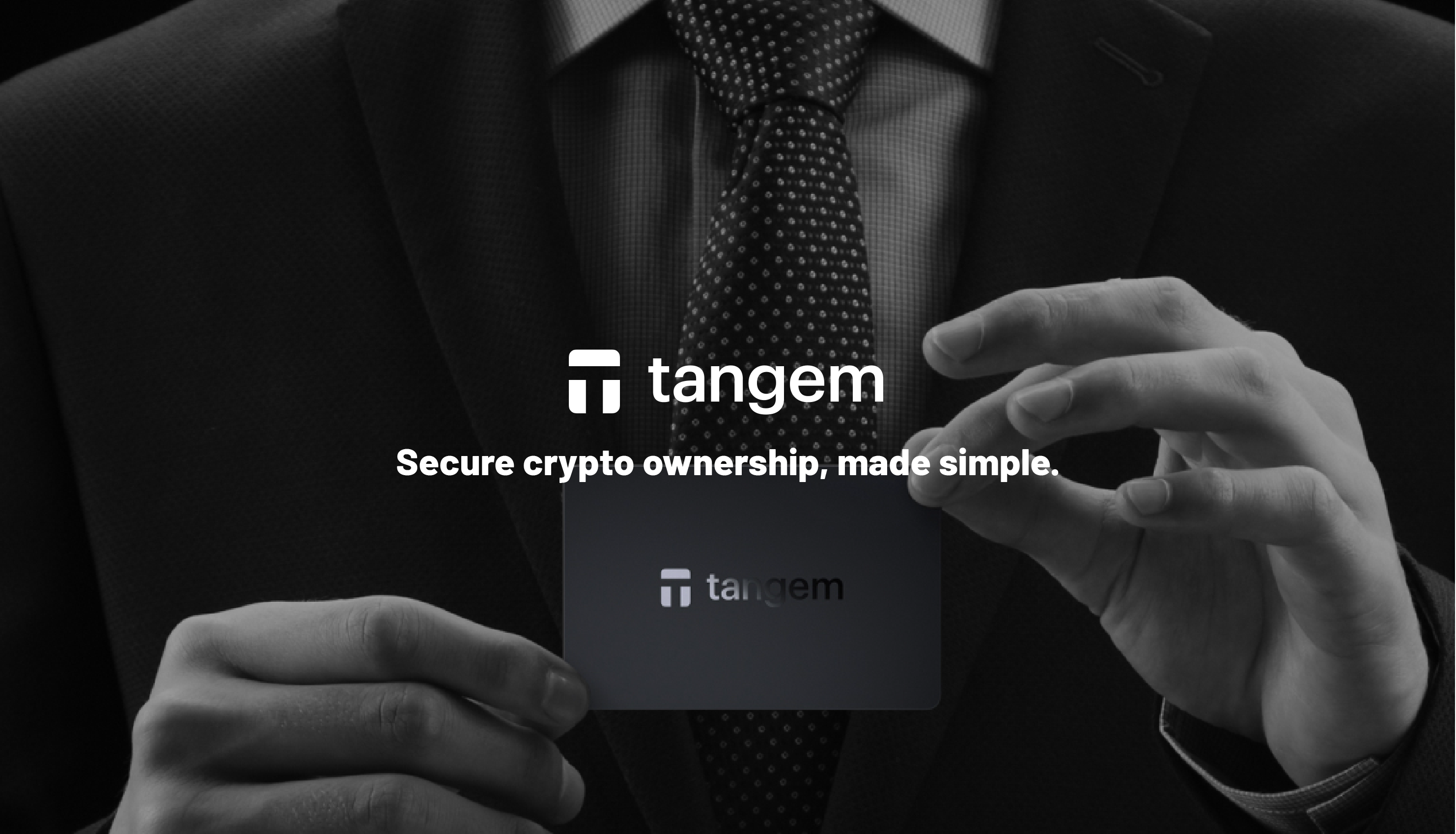 Person holding a Tangem card with the brand's logo and tagline.